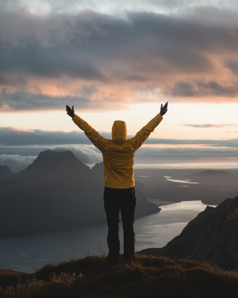 a-photo-of-a-person-standing-on-a-mounta_DstfBwAhSIuD1GVtZ4K55g_8fB3GyspTnWsLVeaxr0BkA Person celebrating financial freedom on a mountain top